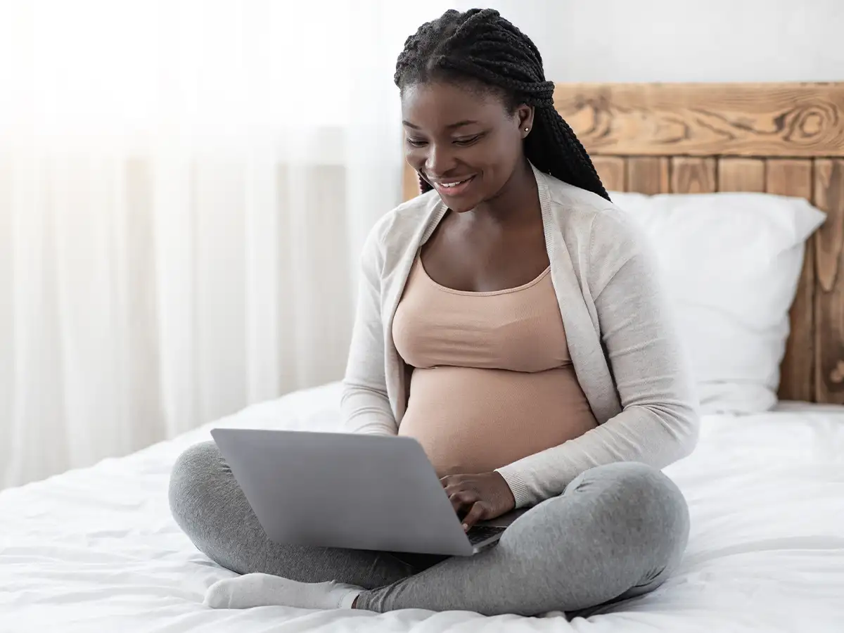 Resources Hero Image showing pregnant woman using a laptop